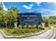 A sign for Town Shores of Gulfport surrounded by plants, flowers, and palm trees at 3128 59Th S St # 214, Gulfport, FL 33707