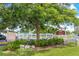 Welcome to the Eton sign with tropical plants and a large shade tree at 3128 59Th S St # 214, Gulfport, FL 33707