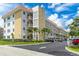Exterior of complex with parking spaces and lush landscaping and multiple balconies at 3128 59Th S St # 214, Gulfport, FL 33707