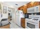This kitchen features a white refrigerator, modern microwave, and gas range stove providing a convenient setup at 3128 59Th S St # 214, Gulfport, FL 33707