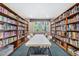 Library with floor to ceiling bookshelves on either side of a long table and chairs at 3128 59Th S St # 214, Gulfport, FL 33707