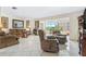 Spacious living room featuring tile floors, comfortable seating, and large windows offering scenic outdoor views at 3128 59Th S St # 214, Gulfport, FL 33707