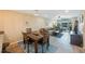 Charming dining area with wood table and chairs, near living room at 175 116Th Ave # 102, Treasure Island, FL 33706