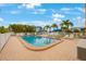Community pool with lounge chairs and patio at 175 116Th Ave # 102, Treasure Island, FL 33706