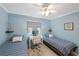 Bright bedroom with twin beds, desk, and window coverings at 175 116Th Ave # 102, Treasure Island, FL 33706