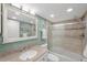 Bathroom with granite vanity, shower/tub combo, and tiled walls at 175 116Th Ave # 102, Treasure Island, FL 33706