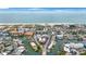Aerial view of a coastal community with beach, water and various buildings at 175 116Th Ave # 102, Treasure Island, FL 33706