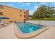 Community pool area with patio and lounge chairs at 175 116Th Ave # 102, Treasure Island, FL 33706