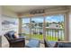 Bright sunroom with wicker furniture and stunning water views at 175 116Th Ave # 102, Treasure Island, FL 33706
