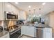 Modern kitchen with stainless steel appliances and granite countertops at 175 116Th Ave # 102, Treasure Island, FL 33706