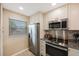 Modern kitchen with stainless steel appliances and granite countertops at 175 116Th Ave # 102, Treasure Island, FL 33706