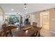 Bright dining area with wood table and chairs, adjacent to living room and bathroom at 175 116Th Ave # 102, Treasure Island, FL 33706