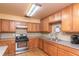 Well-equipped community kitchen with wood cabinets at 5980 80Th N St # 210, St Petersburg, FL 33709