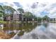 Community lakefront view with reflection of buildings and trees at 5980 80Th N St # 210, St Petersburg, FL 33709