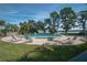 Community pool area with lounge chairs and scenic waterfront views at 1111 N Bayshore Blvd # C7, Clearwater, FL 33759