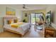Relaxing bedroom featuring sliding glass doors, a hanging chair, and wood floors at 308 Mariner Dr # 308, Tarpon Springs, FL 34689