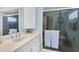 Clean bathroom with white vanity, shower stall and a mirrored medicine cabinet at 5130 Brittany S Dr # 106, St Petersburg, FL 33715