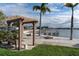 Scenic waterfront walkway with pergola and bench for relaxation at 5130 Brittany S Dr # 106, St Petersburg, FL 33715