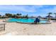 Expansive, inviting community pool with palm trees and water access at 5130 Brittany S Dr # 106, St Petersburg, FL 33715