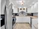 Well-equipped kitchen featuring white cabinetry and modern appliances at 5130 Brittany S Dr # 106, St Petersburg, FL 33715