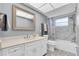 Elegant bathroom with white cabinets, marble shower and a large mirror at 5130 Brittany S Dr # 106, St Petersburg, FL 33715