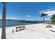 Peaceful waterfront view with a bench, pier and calm waters at 5130 Brittany S Dr # 106, St Petersburg, FL 33715