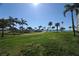 Expansive green lawn with palm trees and a view of the waterfront at 5130 Brittany S Dr # 106, St Petersburg, FL 33715