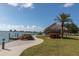Beachfront kayak storage with a thatched roof and walking path at 5130 Brittany S Dr # 106, St Petersburg, FL 33715