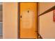 Condo building entrance with an orange door and number 209 at 8911 Blind Pass Rd # 209, St Pete Beach, FL 33706