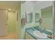 Clean bathroom with light teal vanity and tiled floor at 308 Mariner Dr # 308, Tarpon Springs, FL 34689