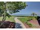 Peaceful waterfront pathway with lush landscaping leading to scenic bay views at 308 Mariner Dr # 308, Tarpon Springs, FL 34689