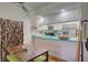 Kitchen dining area with teal counter and wooden table at 308 Mariner Dr # 308, Tarpon Springs, FL 34689