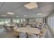 Bright community room with tables and chairs for gatherings at 308 Mariner Dr # 308, Tarpon Springs, FL 34689