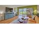 Bright living room with hardwood floors and sliding glass doors to patio at 308 Mariner Dr # 308, Tarpon Springs, FL 34689