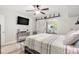 Spacious bedroom featuring a sliding barn door and modern ceiling fan at 4071 55Th N Way # 1051, Kenneth City, FL 33709