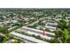 Aerial view of condo complex with mature trees and a community pond at 4071 55Th N Way # 1051, Kenneth City, FL 33709