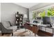 Home office boasts a large desk, bookshelf and comfortable chair at 4071 55Th N Way # 1051, Kenneth City, FL 33709