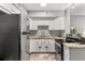 Eat-in kitchen boasts granite countertops, stainless appliances, and white cabinets at 4071 55Th N Way # 1051, Kenneth City, FL 33709