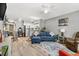 Open concept living room features wood floors, neutral paint and adjacent kitchen at 4071 55Th N Way # 1051, Kenneth City, FL 33709
