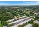Aerial view showcasing the condo's location, landscaping, and distant city skyline at 4071 55Th N Way # 1051, Kenneth City, FL 33709