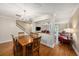 Dining room with hardwood floors and a wooden table, open to the living room at 3455 41St S Ter # 208, St Petersburg, FL 33711