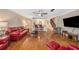 Open living space with hardwood floors, red leather furniture, and a kitchen view at 3455 41St S Ter # 208, St Petersburg, FL 33711