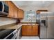 Kitchen with granite countertops, stainless steel appliances, and wood cabinets at 3455 41St S Ter # 208, St Petersburg, FL 33711