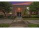 Brick building exterior at dusk with a walkway leading to the entrance at 3455 41St S Ter # 208, St Petersburg, FL 33711