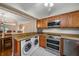 Kitchen with stainless steel appliances, wood cabinets, and a view of the dining room at 3455 41St S Ter # 208, St Petersburg, FL 33711