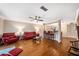 Open living space with hardwood floors, red leather furniture, and a kitchen view at 3455 41St S Ter # 208, St Petersburg, FL 33711
