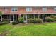 Brick building with grassy backyard and screened porches at 3455 41St S Ter # 208, St Petersburg, FL 33711