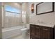 Clean bathroom with dark brown vanity and a glass-enclosed tub at 6016 82Nd N Ter, Pinellas Park, FL 33781