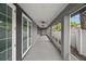 Long screened-in porch with two ceiling fans and double doors at 6016 82Nd N Ter, Pinellas Park, FL 33781