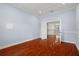 Spacious bedroom with hardwood floors and access to upper hallway at 6016 82Nd N Ter, Pinellas Park, FL 33781
